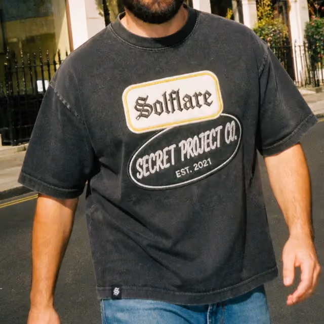 Washed black tee with an embroidered chest badge