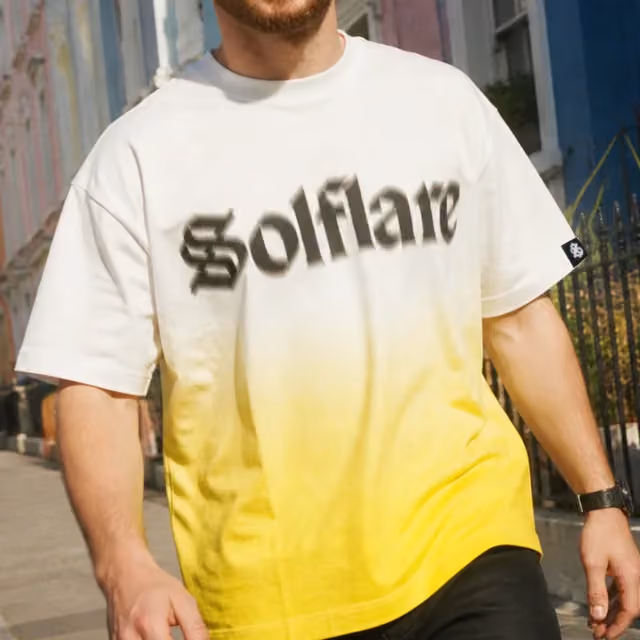 Dip-dyed tee fading from cream to yellow, with a wide chest wordmark