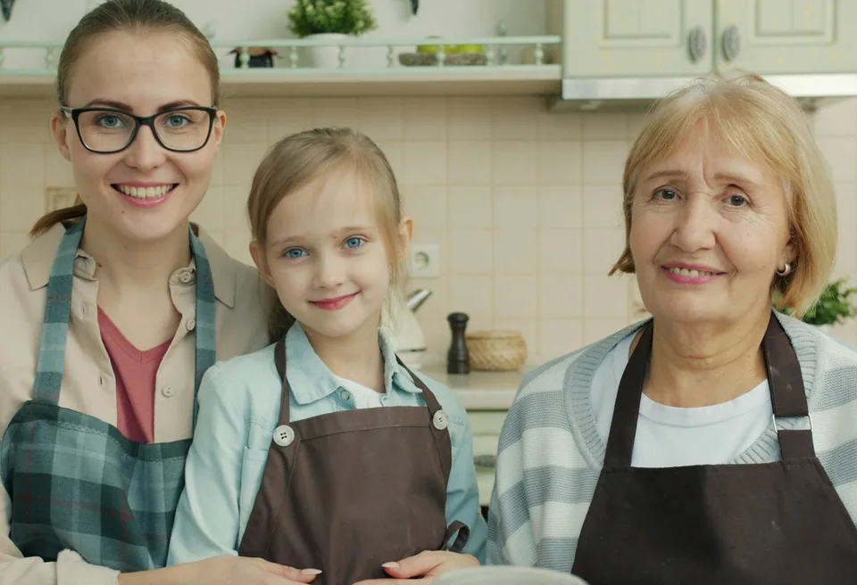 Three generations of a family cooking together