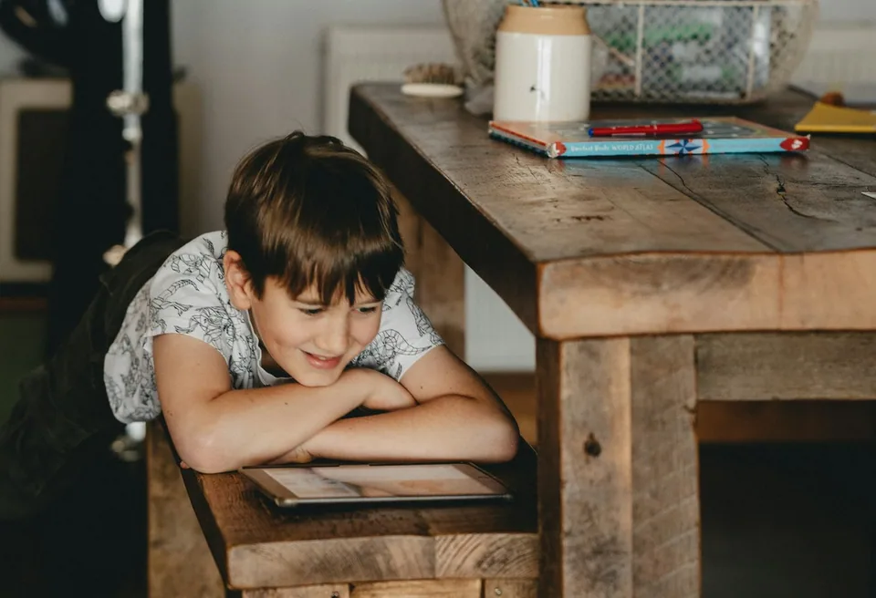 A boy drawing at a table